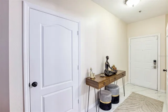 a living room that has a couch and a stove with wooden floor