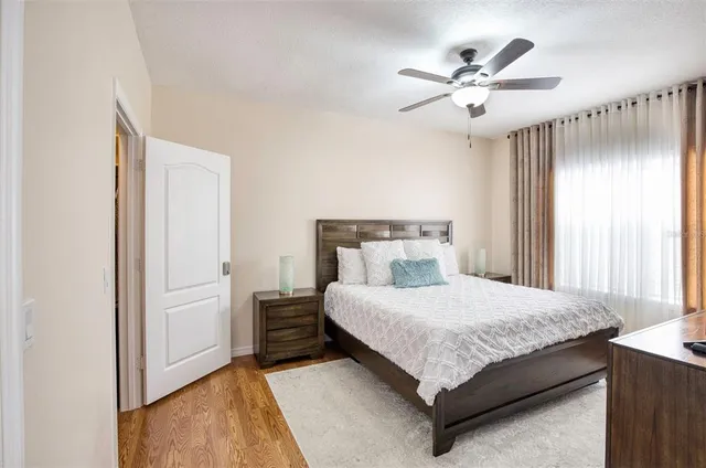 a bedroom with a large bed and a chandelier