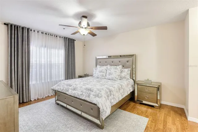 a spacious bedroom with a bed and a chandelier