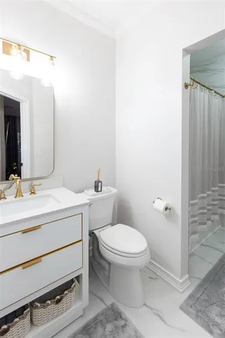 a bathroom with a sink mirror vanity and toilet