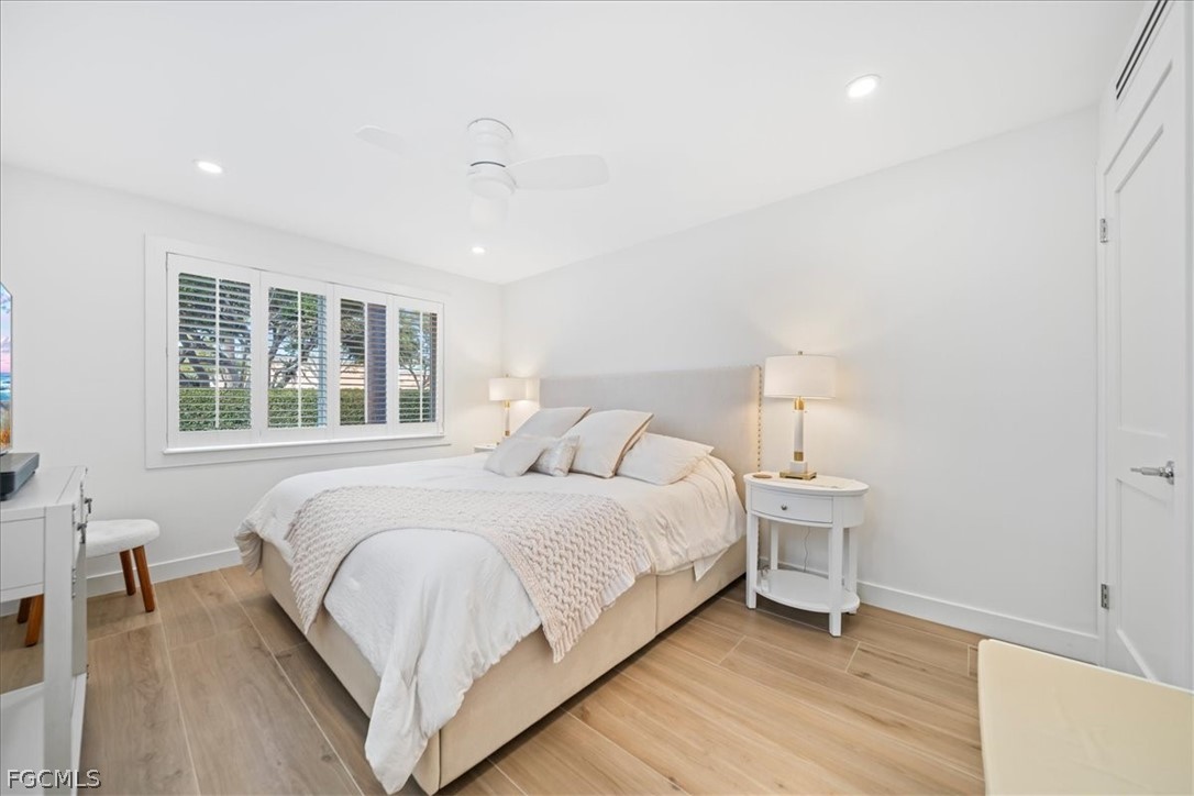 72 7th Street South, Unit 112 Naples, FL 34102 - Photo 13 of 28 a bedroom with a bed and a large window
