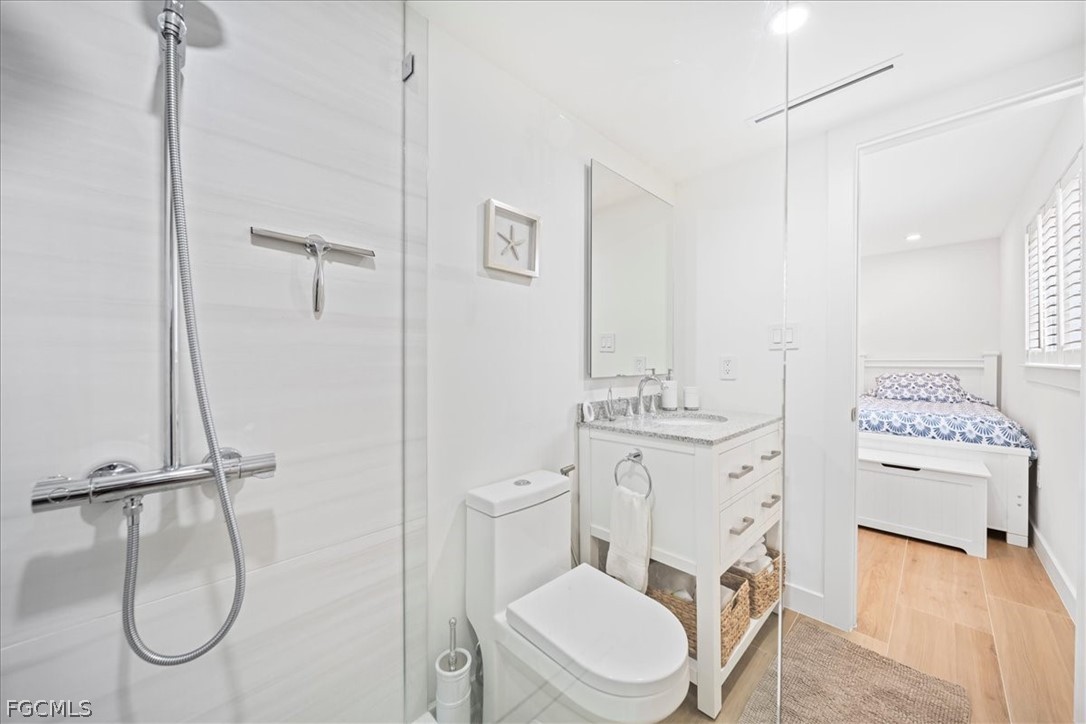 72 7th Street South, Unit 112 Naples, FL 34102 - Photo 17 of 28 a bathroom with a toilet sink and shower