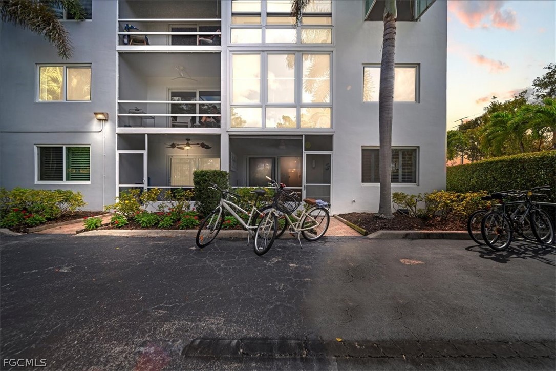 72 7th Street South, Unit 112 Naples, FL 34102 - Photo 20 of 28 a view of a brick house with many windows and potted plants
