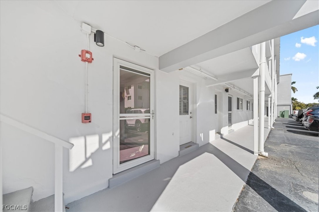 72 7th Street South, Unit 112 Naples, FL 34102 - Photo 4 of 28 a bedroom with furniture and white walls