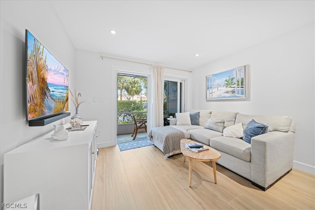 72 7th Street South, Unit 112 Naples, FL 34102 - Photo 9 of 28 a living room with furniture and a large window