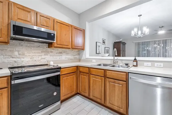 a kitchen with sink and cabinets
