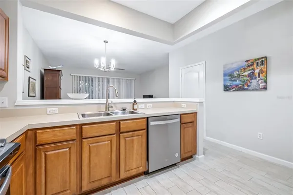 a kitchen with a sink cabinets and wooden floor