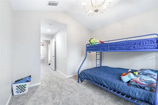 a view of a white house with a large window and a yard with large windows