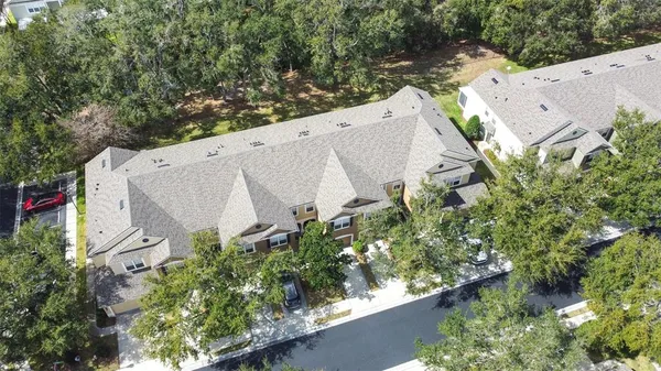 an aerial view of a house with outdoor space swimming pool and lake view