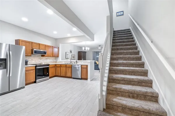 a kitchen with a sink refrigerator and a microwave