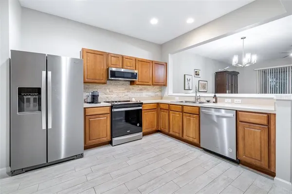 a kitchen with granite countertop stainless steel appliances and sink