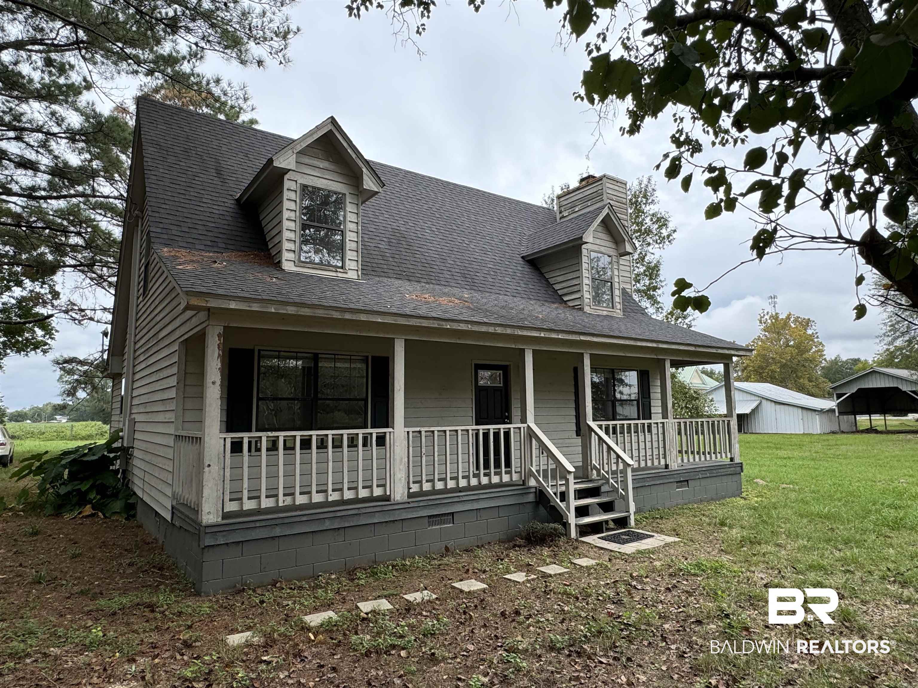 70 Plum Street Uriah, AL 36480 - Photo 2 of 36 New england style home featuring a front yard and covered porch
