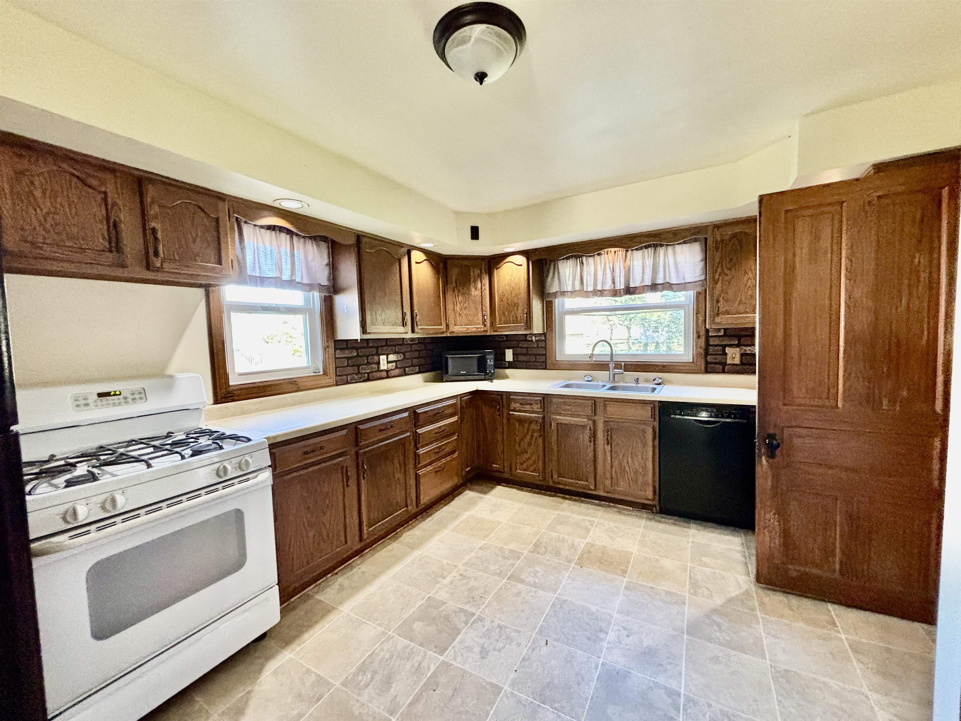 231 Bennett Street Belvidere, IL 61008 - Photo 11 of 24 a kitchen with stainless steel appliances granite countertop a stove a sink dishwasher a refrigerator and a microwave oven