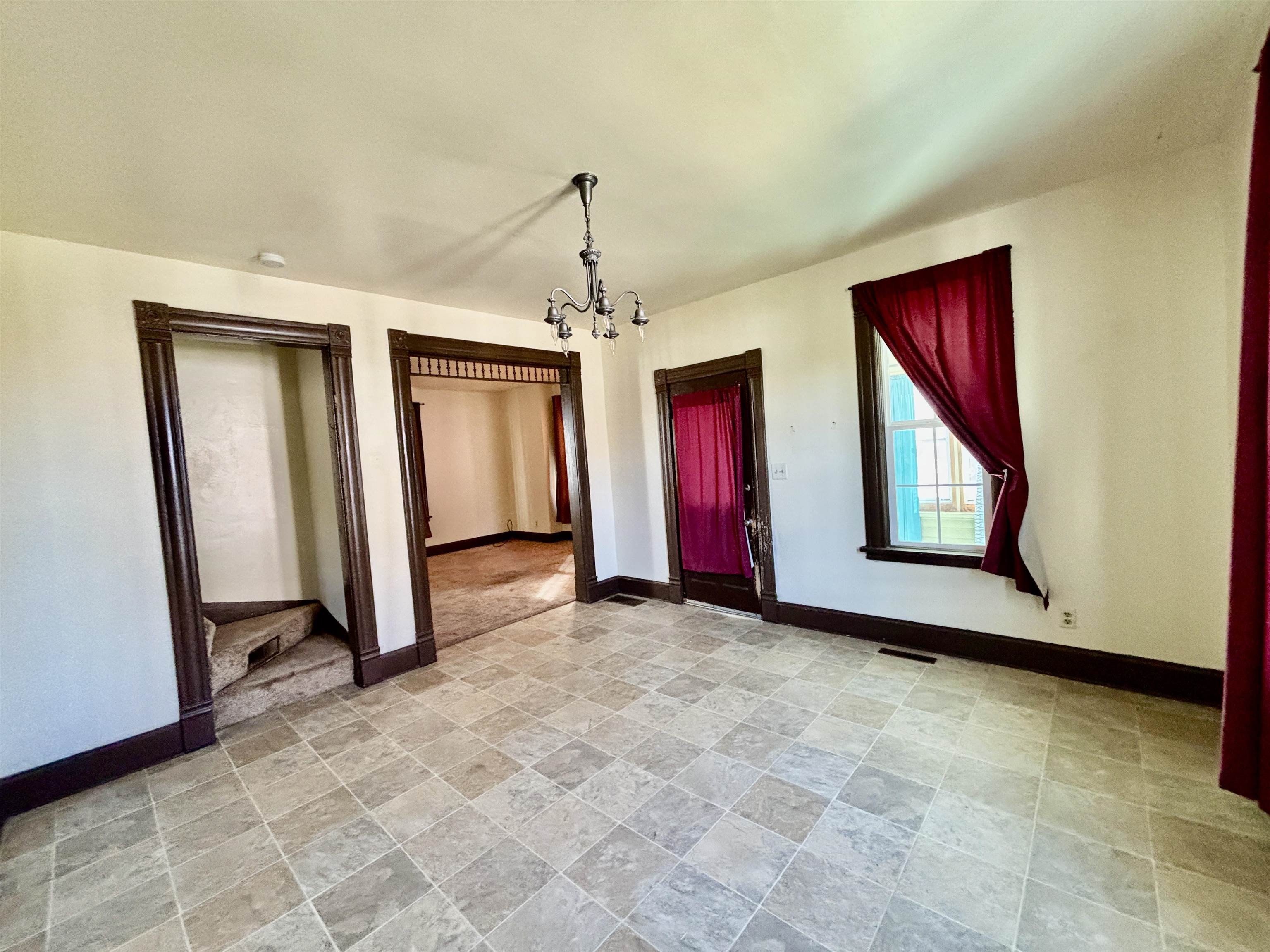 231 Bennett Street Belvidere, IL 61008 - Photo 7 of 24 a view of an empty room with window and chandelier fan