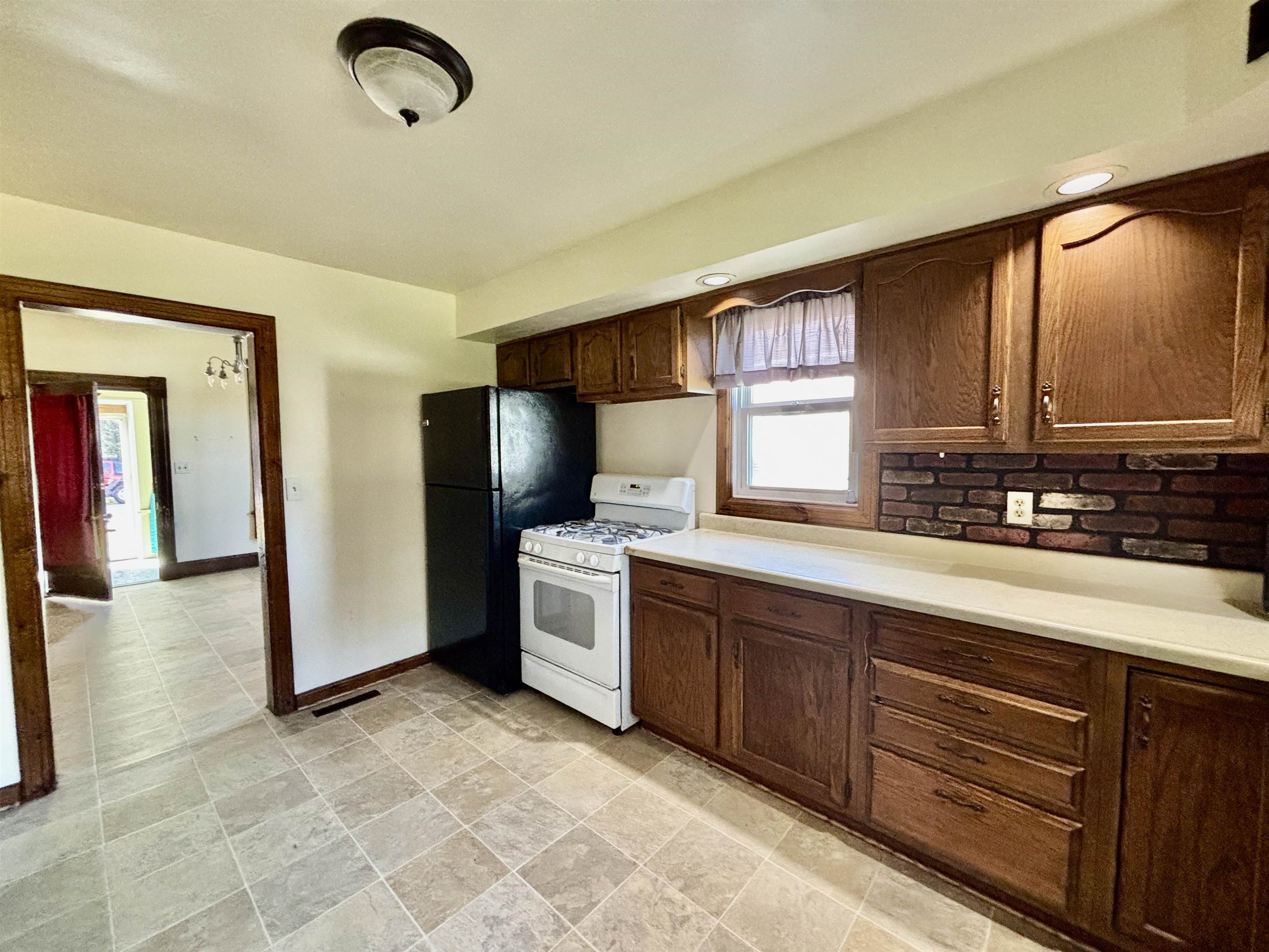231 Bennett Street Belvidere, IL 61008 - Photo 9 of 24 a kitchen with stainless steel appliances granite countertop a sink and a stove