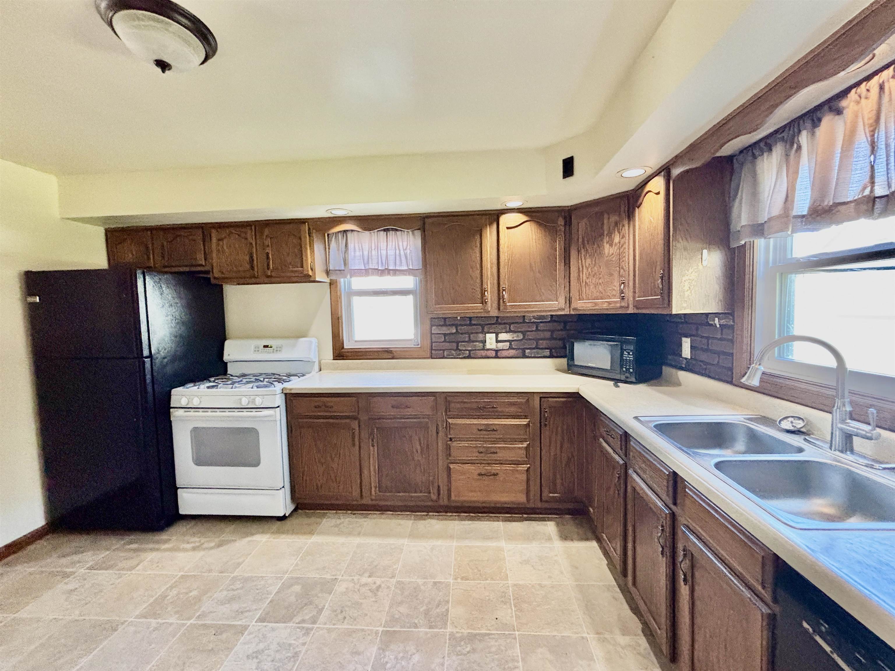 231 Bennett Street Belvidere, IL 61008 - Photo 10 of 24 a kitchen with stainless steel appliances granite countertop a sink stove and refrigerator