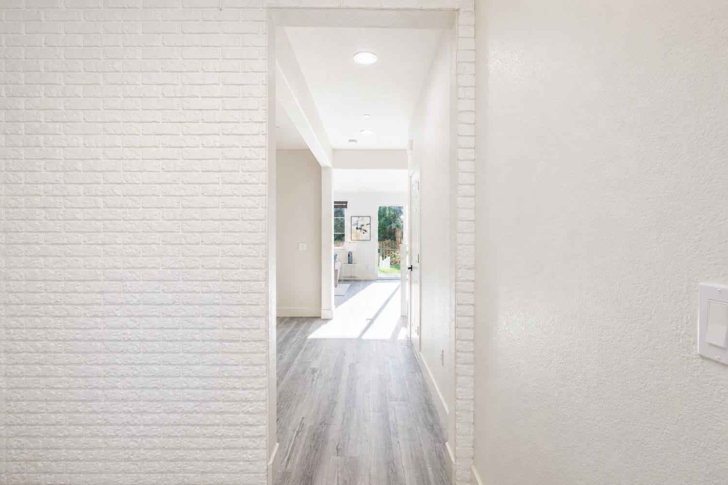 1837 South La Barbera Avenue Mountain House, CA 95391 - Photo 7 of 54 a view of a hallway with wooden floor