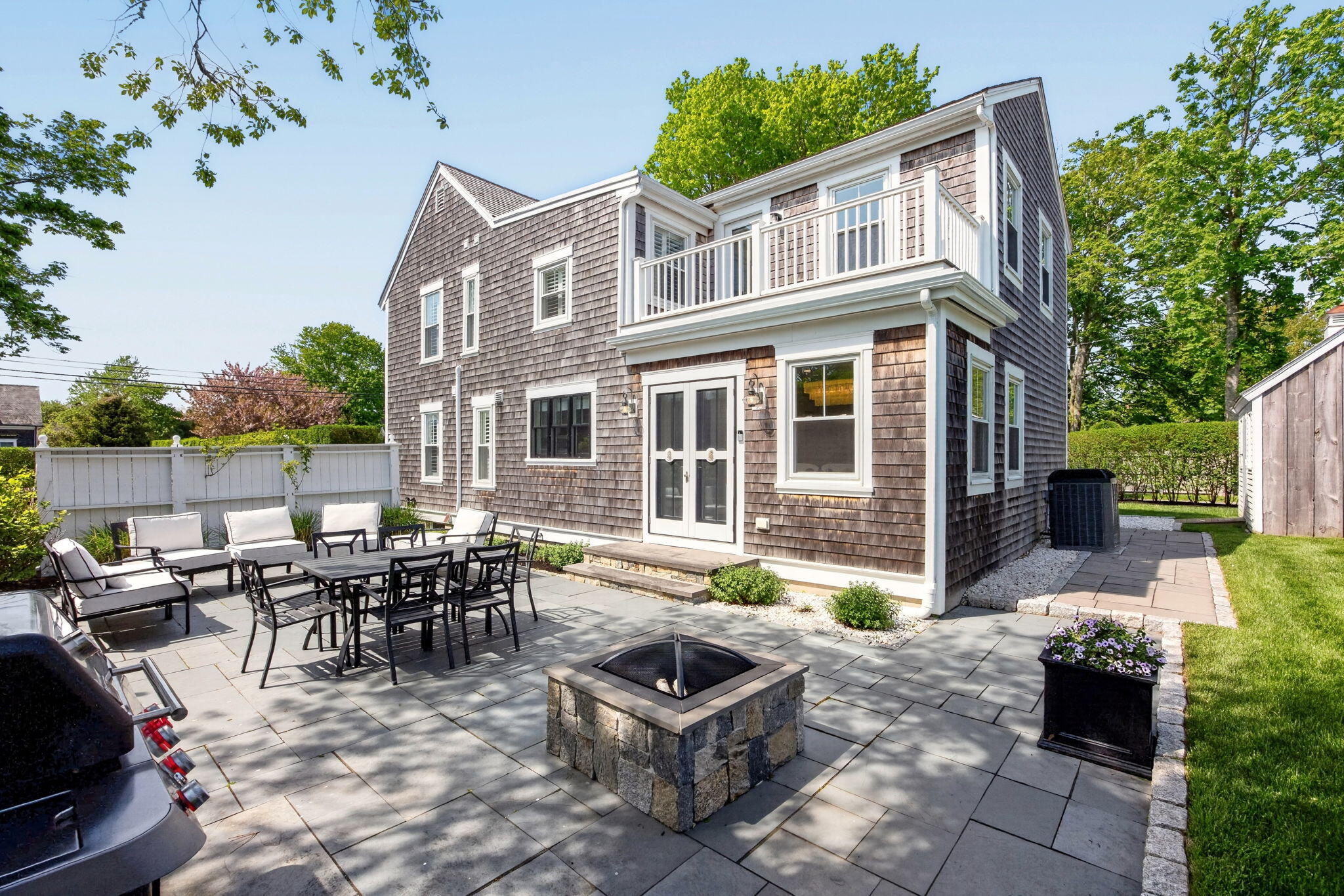 320 Old Harbor Road Chatham, MA 02633 - Photo 7 of 58 a front view of a house with outdoor seating