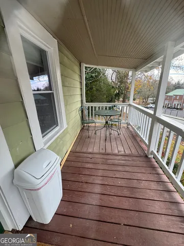 a view of a chair and tables in the balcony