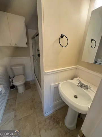 a bathroom with a sink toilet and shower