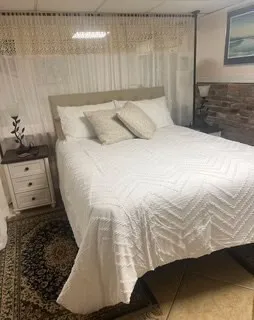 a bedroom with a bed and a window