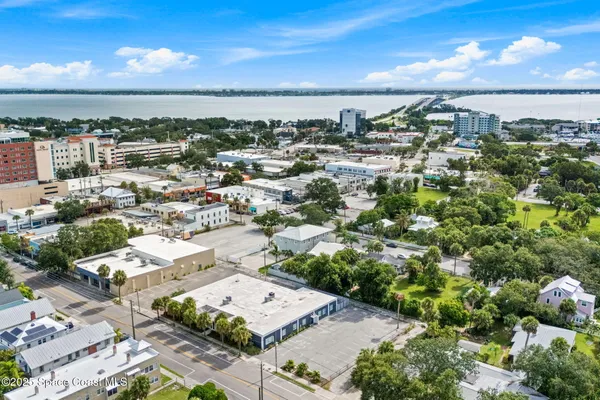 a view of a house with a wooden fence and large windows