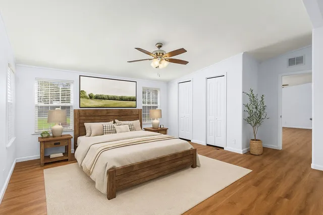 a bedroom with a bed and a potted plant
