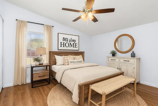 a bedroom with a bed a table and chair