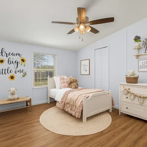 a spacious bedroom with a bed and a window