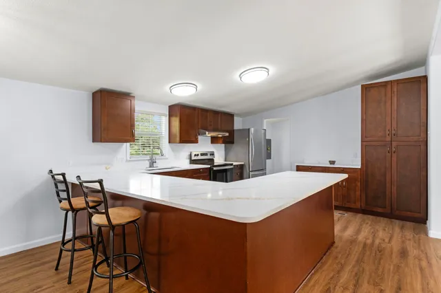 a kitchen with a table chairs and a refrigerator