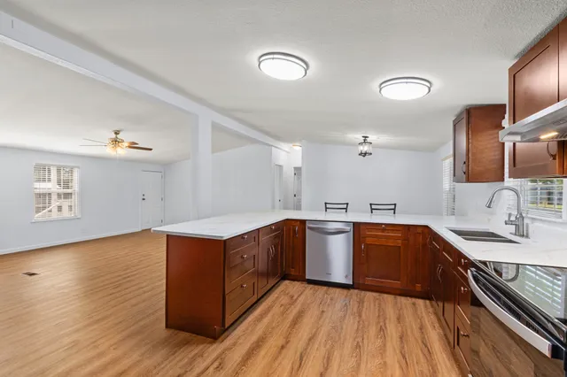 a kitchen with wooden cabinets and sink