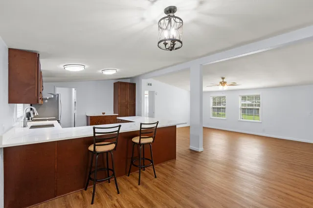 a view of a dining room with furniture wooden floor and chandelier