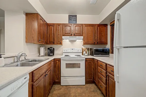 a kitchen with a sink cabinets and appliances