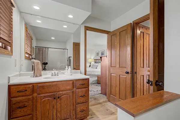 a bathroom with a sink a mirror and a shower