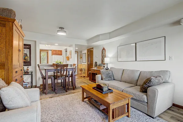 a living room with furniture a dining table and a window