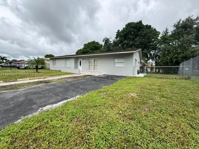a view of a backyard with large trees
