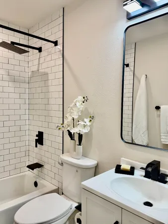 a bathroom with a shower a toilet and a shower