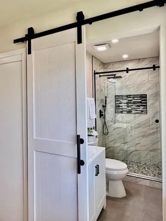 a bathroom with a glass shower door