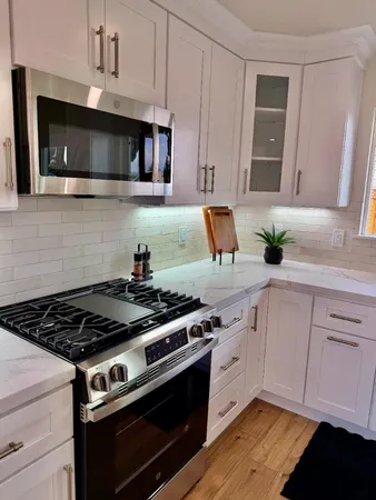 a bathroom with a granite countertop sink and a large mirror
