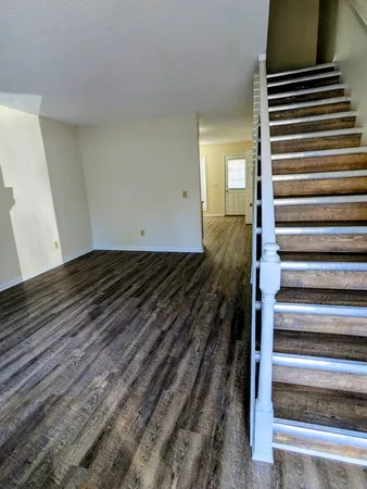 a view of a room with stairs and a rug