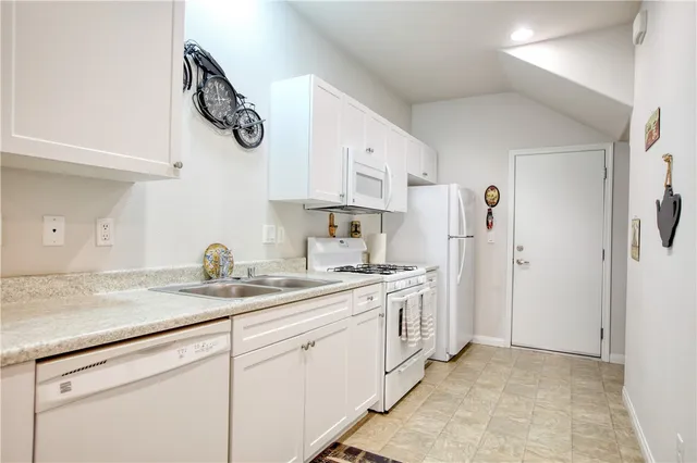 a kitchen with stainless steel appliances granite countertop a sink and a stove