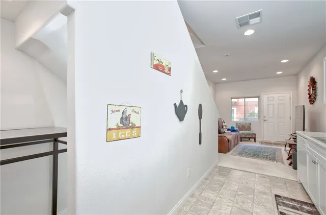 a view of a hallway with furniture and windows