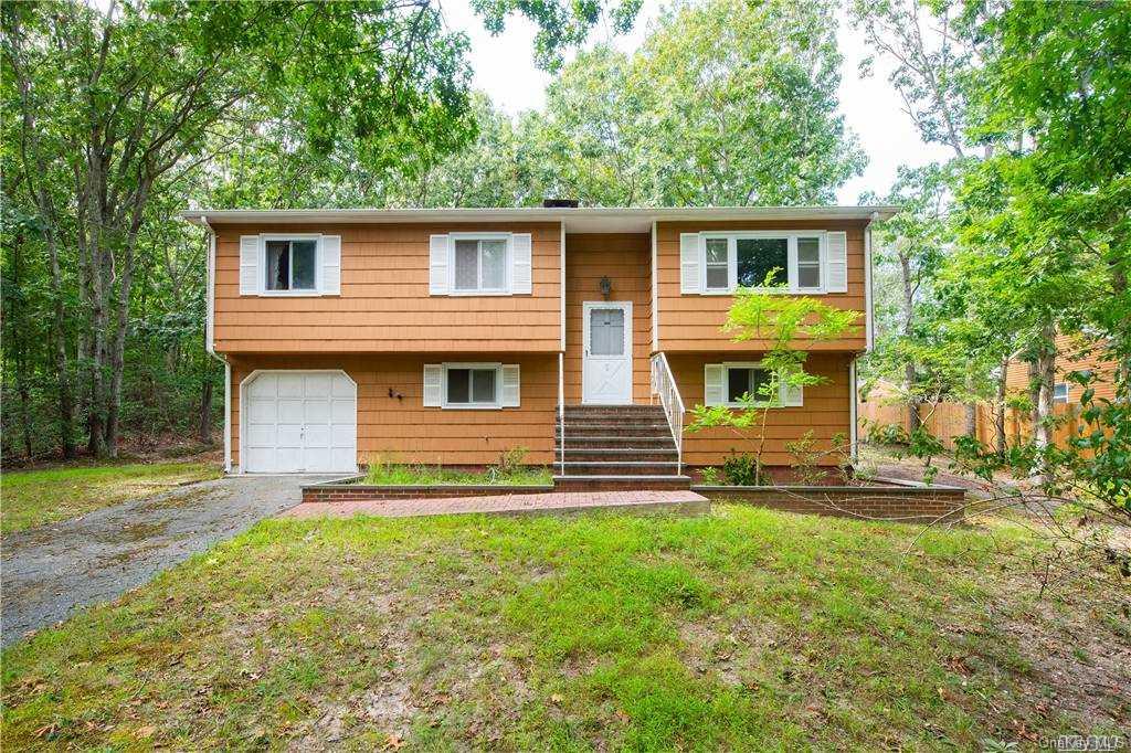 2347 Noyack Road Sag Harbor, NY 11963 - Photo 1 of 1 a front view of a house with a yard