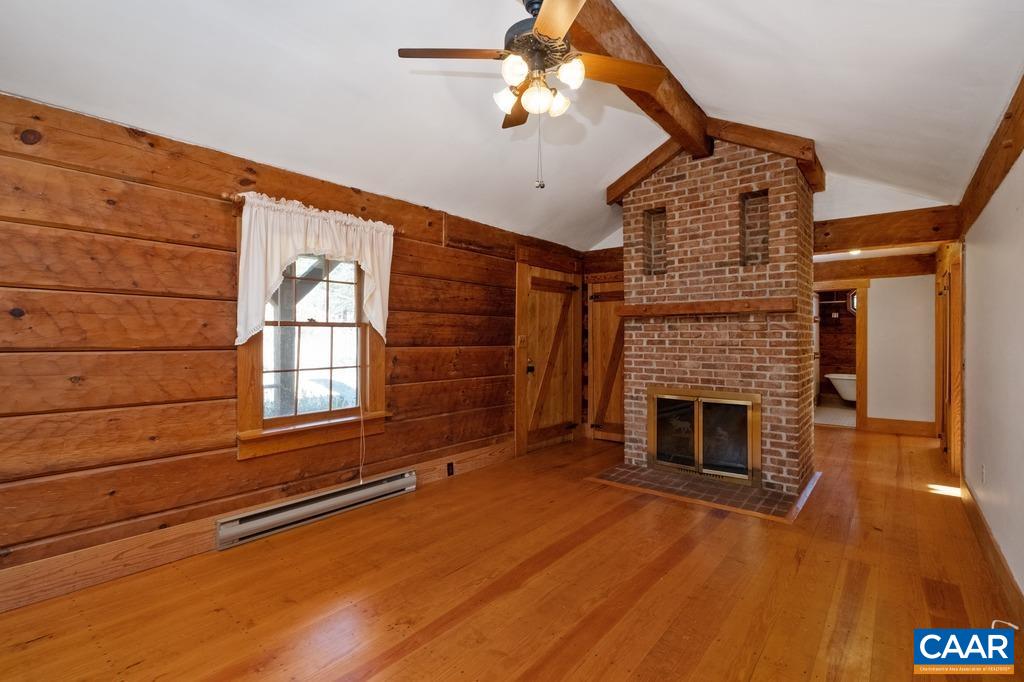 4844 Haden Martin Road Palmyra, VA 22963 - Photo 6 of 40 a view of an empty room with wooden floor fireplace and a window