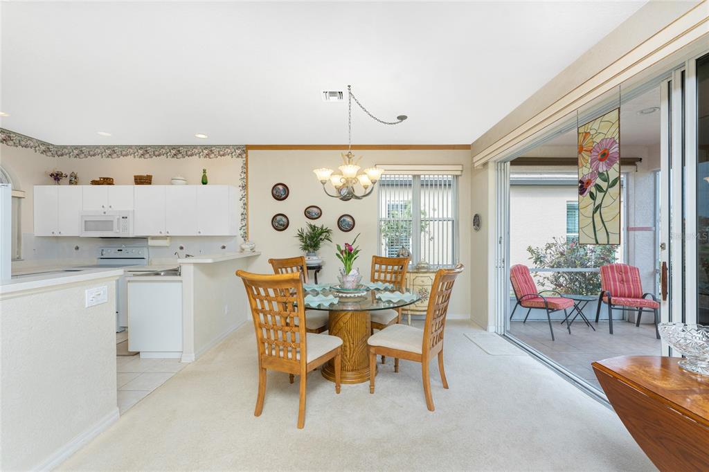 10214 Windsong Road Punta Gorda, FL 33955 - Photo 12 of 68 a view of a dining room with furniture and chandelier