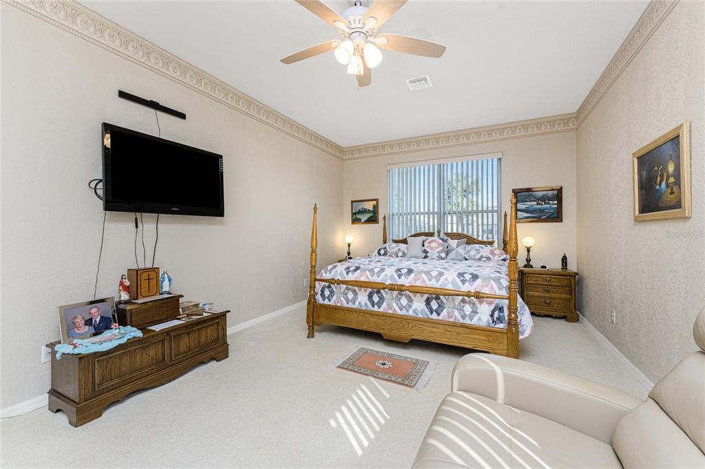 10214 Windsong Road Punta Gorda, FL 33955 - Photo 19 of 68 a bedroom with a bed window and a flat screen television