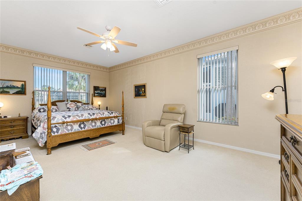 10214 Windsong Road Punta Gorda, FL 33955 - Photo 20 of 68 a bedroom with a bed chairs and window