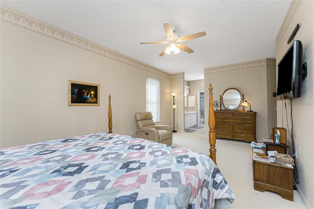 10214 Windsong Road Punta Gorda, FL 33955 - Photo 21 of 68 a bedroom with a bed and a flat screen tv