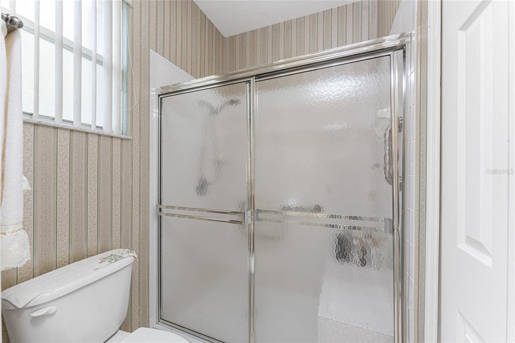 10214 Windsong Road Punta Gorda, FL 33955 - Photo 23 of 68 a bathroom with a shower and toilet