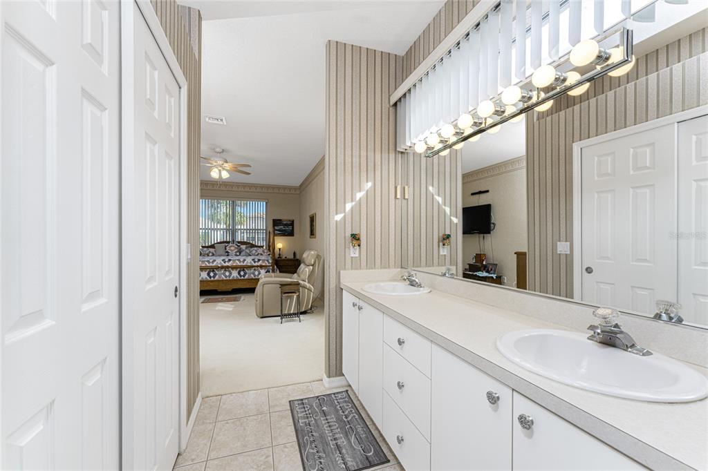 10214 Windsong Road Punta Gorda, FL 33955 - Photo 24 of 68 a bathroom with a sink a mirror and vanity